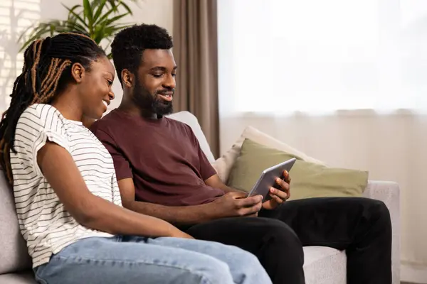 Smiling Couple Enjoying Digital Tablet Sofa Happy Afro Couple Relaxing Royalty Free Stock Images