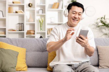Mutlu adam videosu evdeki akıllı telefondan arıyor. Keyif ve rahatlığı gelişigüzel ifade ediyor..