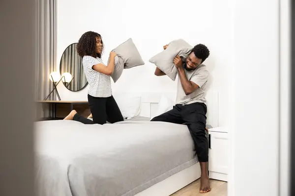 Playful Couple Enjoying Pillow Fight Modern Bedroom Young Man Woman — Stock Photo, Image
