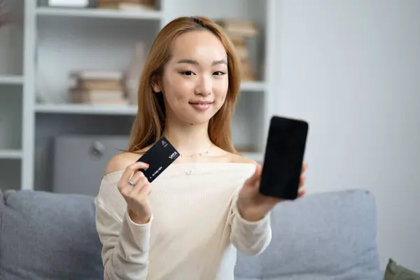 Asian Woman Showcasing Credit Card Smartphone Online Shopping Digital Payment รูปภาพสต็อก