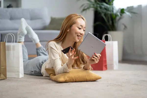 Happy Young Woman Shopping Online Home Smiling She Holds Credit Stok Gambar