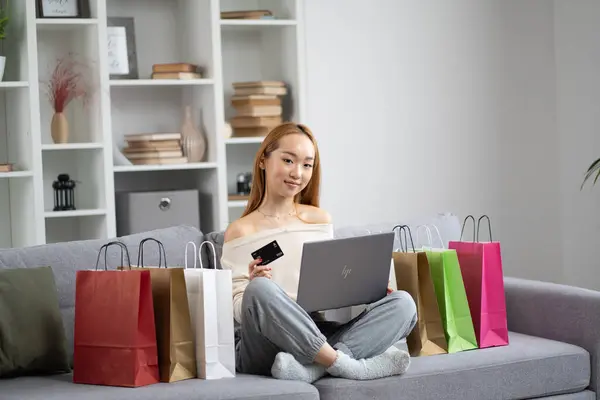 Happy Young Woman Online Shopping Laptop Credit Card Surrounded Colorful รูปภาพสต็อก