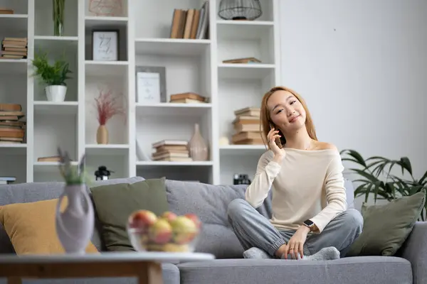 Young Woman Relaxing Sofa Using Smartphone Happy Comfortable Home Environment Stock Photo
