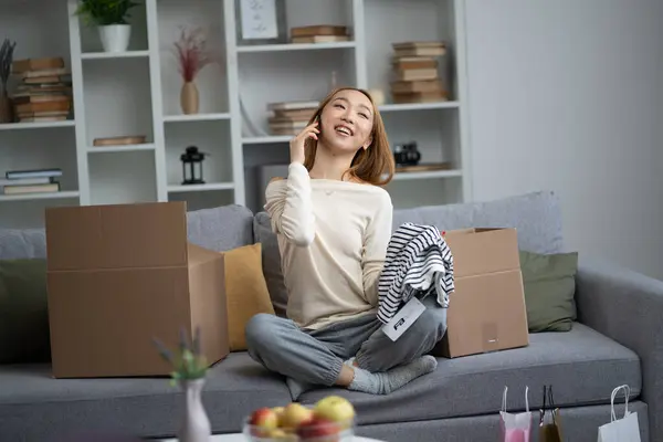 Young Woman Unpacking Boxes Smiling Joyfully While Talking Phone Modern Stock Picture