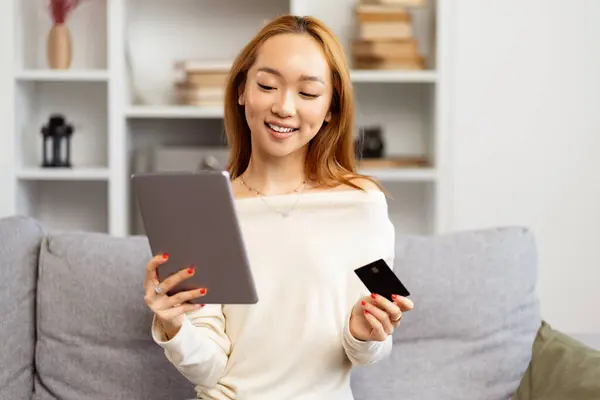 Young Asian Woman Shopping Online Tablet Home Smiling She Holds Stockbild