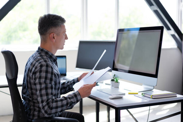 Professional Man Working Desk Modern Office Analyzing Documents Using Computer Stock Picture