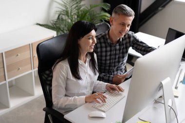 Gülümseyen İş Arkadaşları Ofis Masasında Proje Üzerinde İşbirliği Yapıyor. Takım çalışması, Üretkenlik ve Profesyonellik Konseptleri