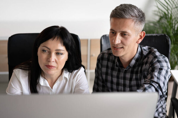 Coworkers Concentrating Computer Screen Office Setting Royalty Free Stock Images