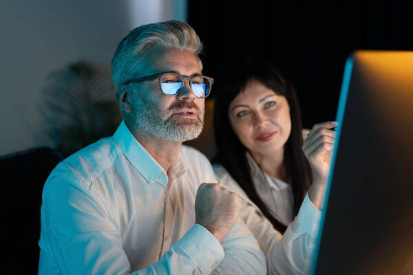 Team Two Business Professionals Working Late Project Focused Screen Displaying Stock Image