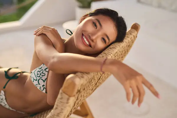 stock image Woman Relaxing Poolside At Resort, Radiant In Sunlight, Embracing Summer Vibes, Enjoying Carefree Vacation, Highlighting Confidence With A Beautiful Smile. Perfect Portrayal Of Body Care, Sun Screen