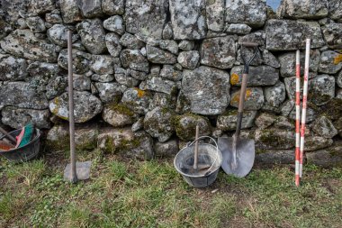 tools of an archaeologist in the excavation of a fortress clipart