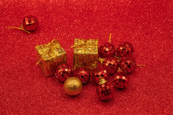 Several red and shiny Christmas balls and one golden ball