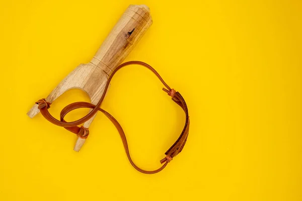Slingshot handmade toy made of wood, leather and rubber. Tirachinas.