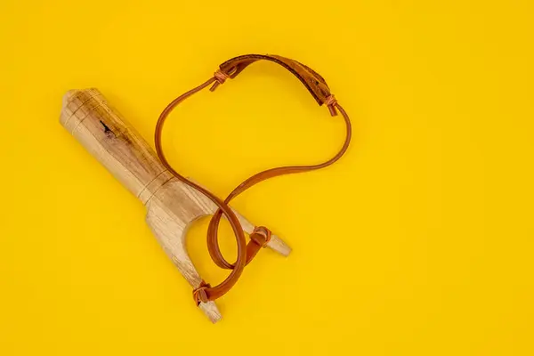 Slingshot handmade toy made of wood, leather and rubber. Tirachinas.