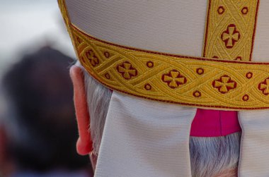 close-up view from behind of the head of a catholic bishop clipart