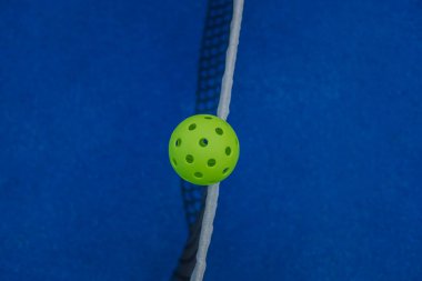 zenithal view of a pickleball ball on the net of a pickleball court clipart