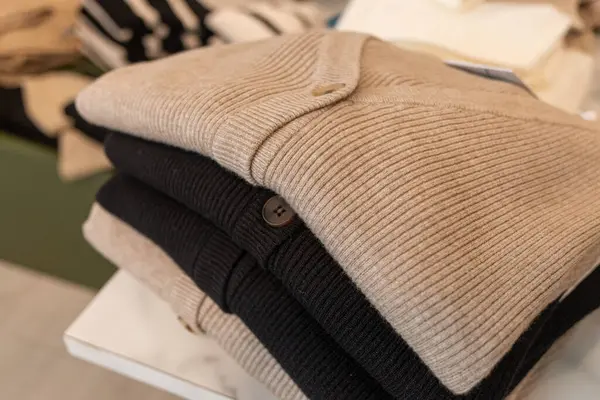 fine wool jackets piled in a clothing store