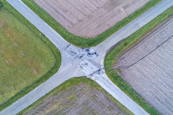 crossroads of roads, aerial view of the intersection of four asphalt tracks, rural area