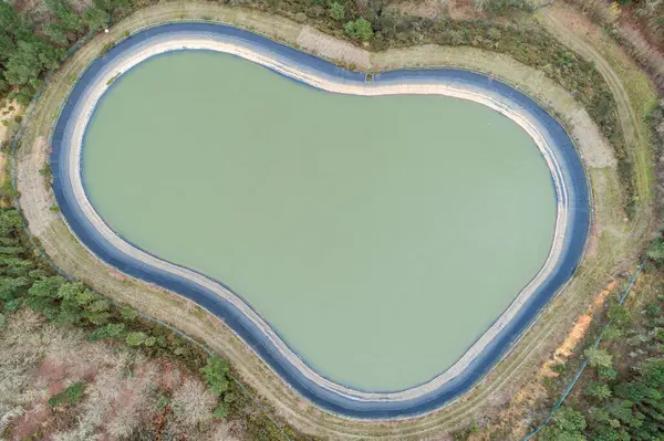 aerial view of a water storage pond in the mountains