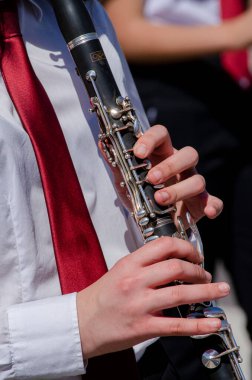 Klarnet çalan bir kızın ellerinin yakın plan görüntüsü, müzik eğitimi.