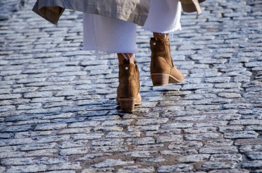 Çizmelerle yürüyen bir kadının ayakları