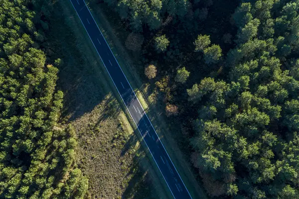 aerial view of a road with a drone at sunset