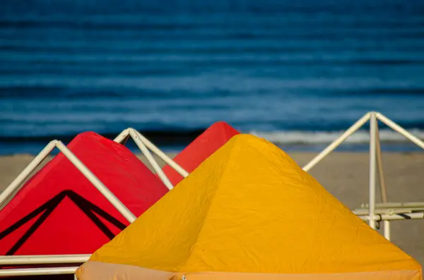 red and yellow colored yellow and red beach cabins, summer concept