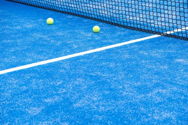 Raket tenis topu mavi raket tenis kortunun ağına doğru gidiyor.