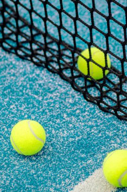 net of a blue paddle tennis court and three balls clipart