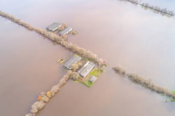 drone aerial view of a farm on flooded agricultural land after spring rains, climate change concept