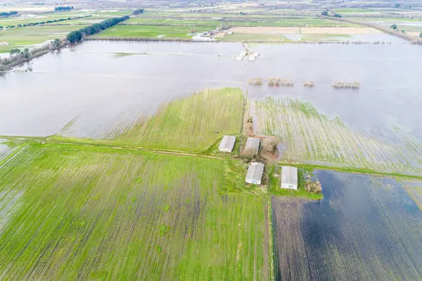 drone aerial view of flooded agricultural fields after spring rains, climate change concept
