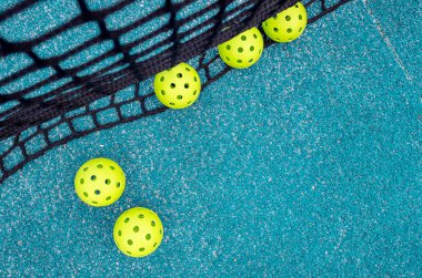 net of a blue pickleball court and five balls clipart