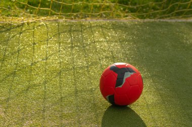 kırmızı futbol topu kaleye yakın suni çim futbol sahasında