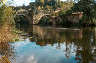 River Arnoia and medieval stone bridge in Allariz. Ourense, Galicia. Spain. clipart