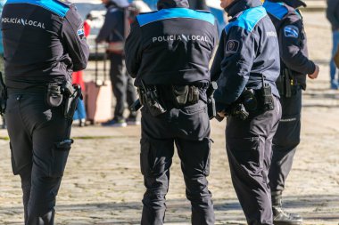 local police officers in the Obradoiro square in Santiago de Compostela. Galicia, Spain clipart