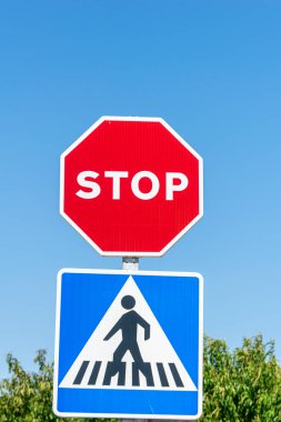 stop sign on a pedestrian crossing isolated against the blue sky, traffic signs concept background clipart