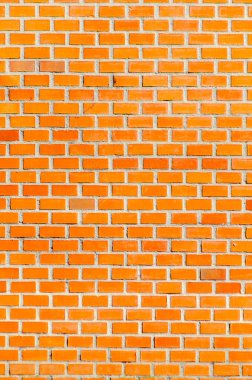 Kırsal turuncu tuğla duvarın yakın görüntüsü arka plan dokusunu ve doğal ışık desenini gösteriyor, inşaat malzemesi konsepti