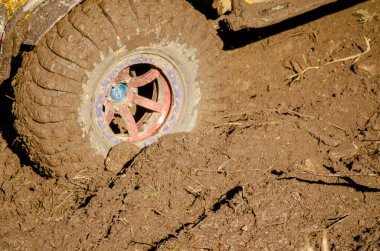 Çamur arazisi lastiğine sıkışmış bir off-road arabasının tekeri. Kirli aracı yakın plan.