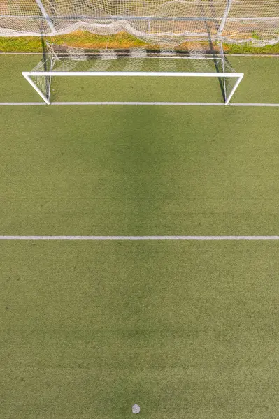 Hedef ve beyaz çizgileri olan modern bir futbol sahası perspektifi, hava aracı görünümü