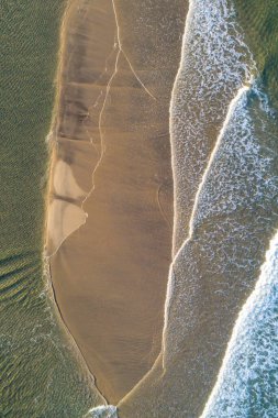 İnsansız hava aracı günbatımında denizin kıyıya vurduğu hassas köpük hatlarını yakalıyor, İHA 'lar tarafından yukarıdan aşağıya doğru havadan çekiliyor. Yaz arkaplanı kavramı