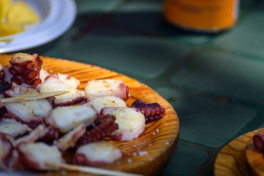 Geleneksel Galiçya tarzı ahtapot ahşap tabakta servis edilir..