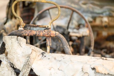 Yangından Sonra Yanık ve Paslı Nesne 'nin Yakın Çekimi. Yıkımın soyut dokusunu kavra.