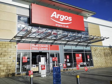 Swansea, UK: January 29, 2020: Argos store front with the website on the commercial sign. clipart