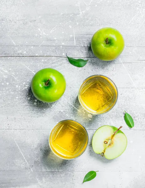 stock image Apple juice in a glass Cup with fresh apples. On rustic background.
