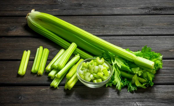 stock image Fresh juicy celery in a bowl. On wooden background