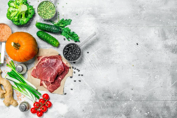 stock image Organic food. Variety of healthy food with beef steaks . On a rustic background.