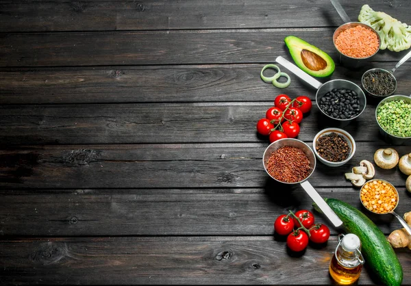 stock image Organic food. Fresh vegetables with spices. On a wooden background.