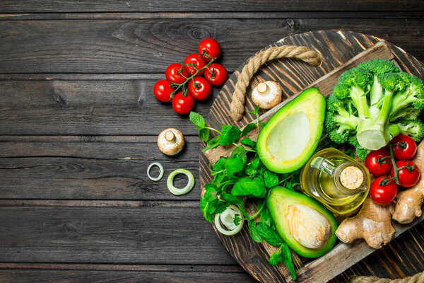 Organic food. Assortment of ripe vegetables in a wooden box. On a wooden background.