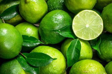 Fresh juicy lime with leaves. Top view clipart