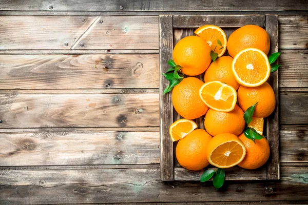 stock image Juicy oranges in tray. On wooden background